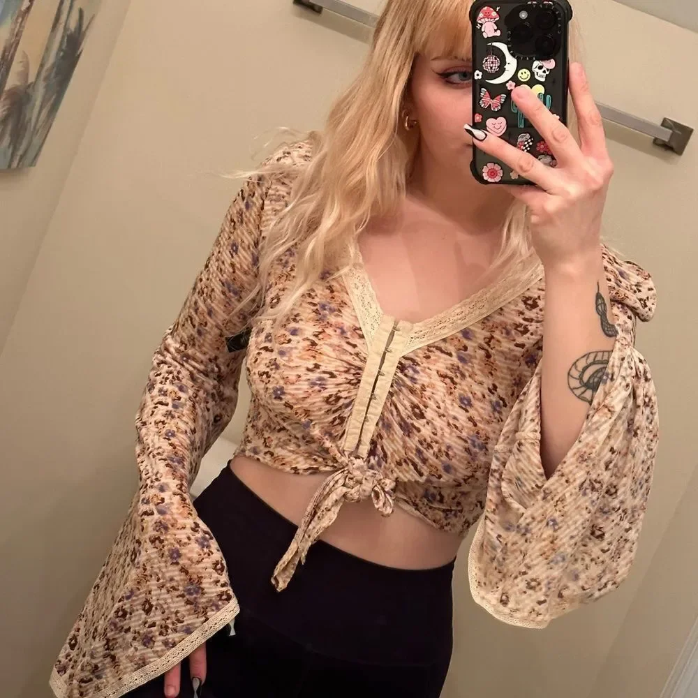 Free People cream and floral clasp front top w tie in front and bell sleeves